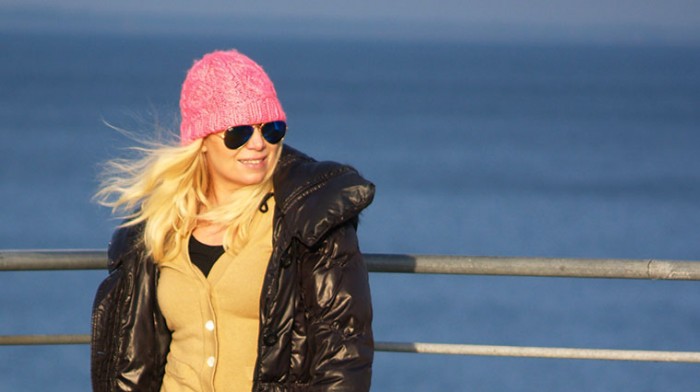 Pink neon beanie with ray-ban sunglasses in blue