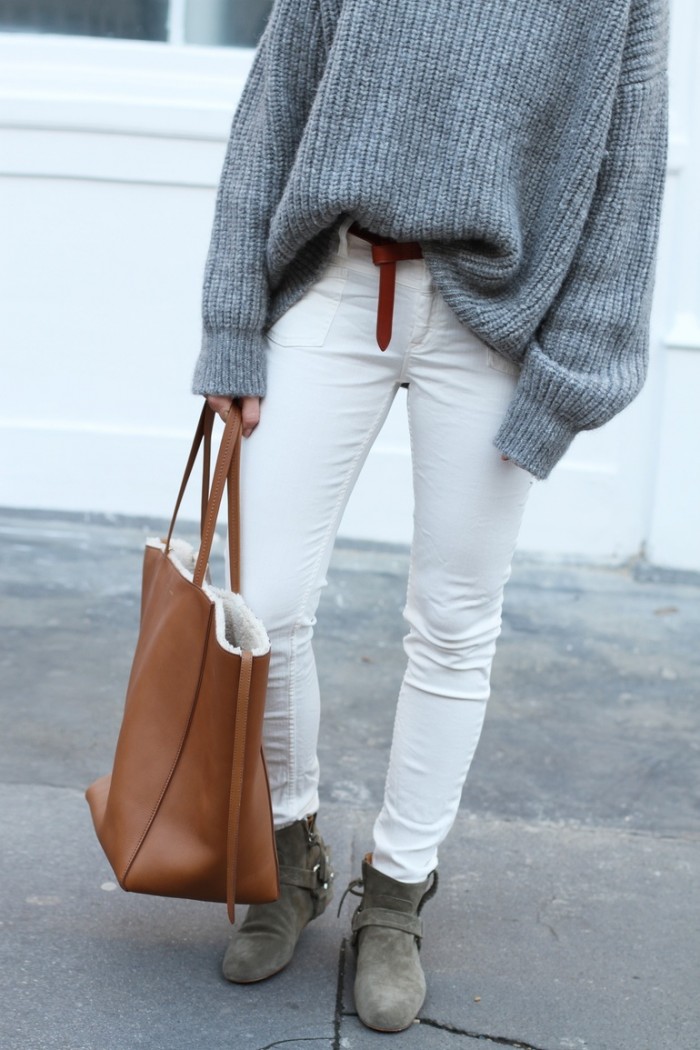 White jeans with a grey knit and brown leather details